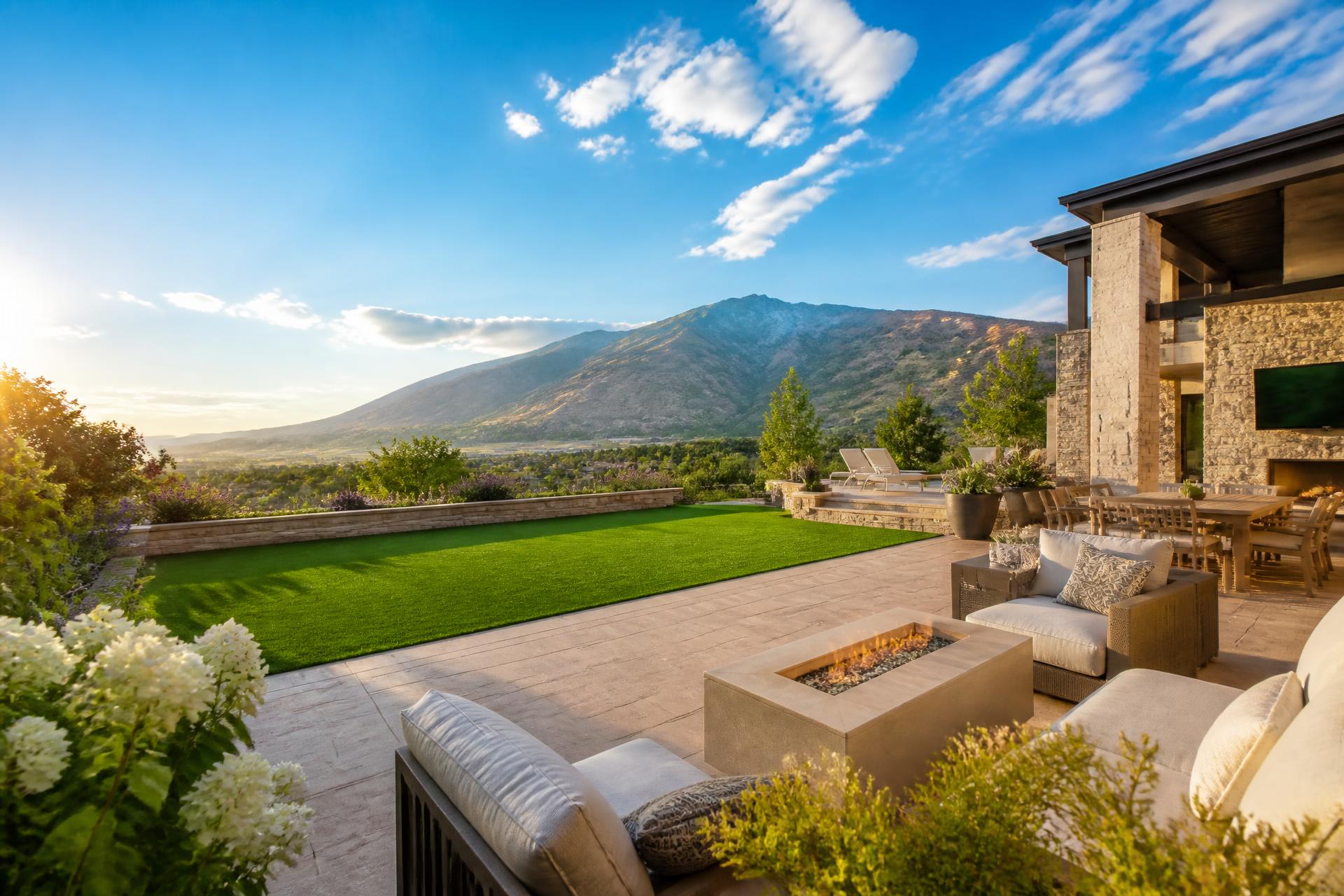 Luxury Utah backyard with artificial turf and paver patio under a Wasatch mountain view